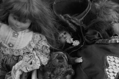 ATHENS, GREECE - JUNE 12, 2015: Antique victorian dolls old toys at street market. Black and white.の写真素材