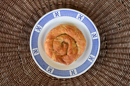 Greek food strifti pita spiral pie filled with feta cheese, leek or spinach. Mediterranean cuisine appetizer dish.の写真素材
