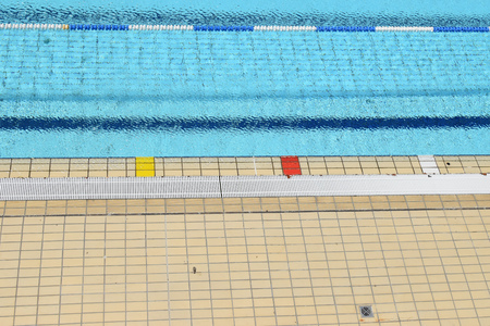 Swimming pool tiled floor and water surface background.の写真素材