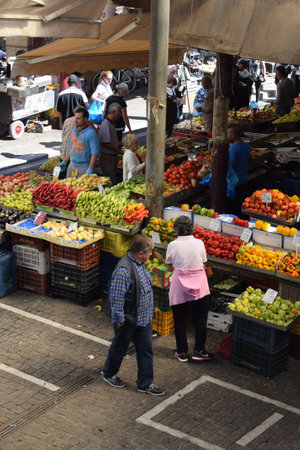 ATHENS, GREECE - OCTOBER 2, 2018: People buying fresh fruit and vegetables at farmers market.のeditorial素材