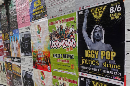Athens, Greece - May 20, 2019: Rock music concert posters for live performances by Iggy Pop Locomondo and Wire plastered on city wall.のeditorial素材