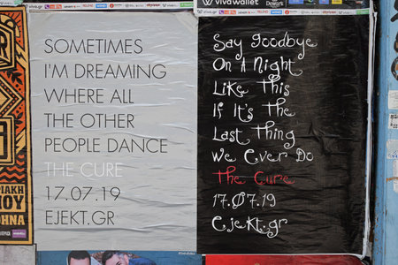 Athens, Greece - March 23, 2019: The Cure new wave rock music group live concert posters with lyrics from albums Faith and Head On The Door on city wall.のeditorial素材