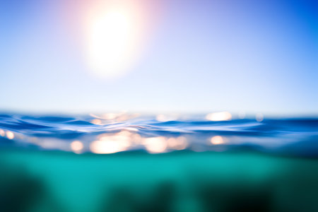 Over under sea water surface and blue sky abstract blur. Generative AI illustration.の素材