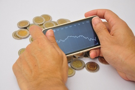 stock graph on mobile and moneyの写真素材