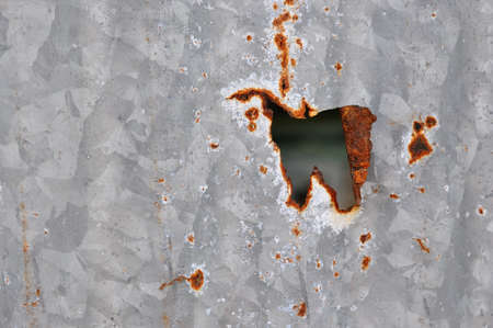 rust zint hole wall backgroundの写真素材