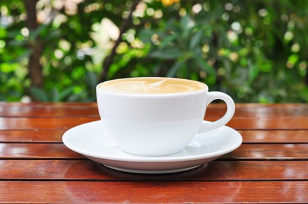 a cup of latte coffee on wood table の写真素材