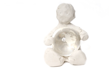 clay man in the world with the ball in the hands isolated on white background の写真素材