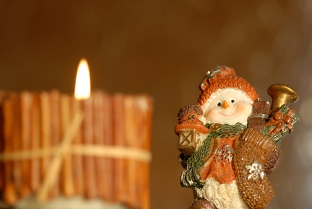 Christmas background, blurred candle and snowman funnyの写真素材
