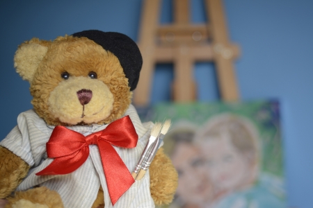 Bear painter with a picture in the backgroundの写真素材