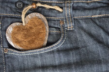 wooden heart in jeans pocketの写真素材