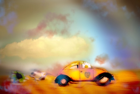 happy holidays, daisy driving a retro car on a beautiful landscapeの写真素材