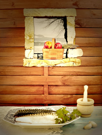 Food, healthy, fresh fish and red apples inside a rustic kitchen with sea viewsの写真素材