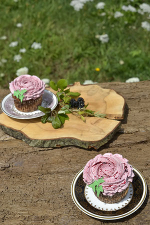 Tasty muffins with blackberries on wooden tableの写真素材