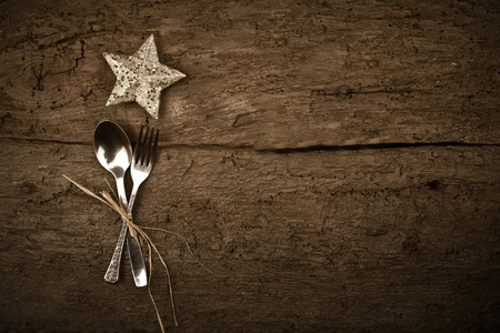 Christmas day dinner with table setting  star in rustic wood style with cutleryの写真素材