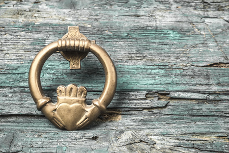 Claddagh, irish symbol of love, friendship and loyalty in old wooden backgroundの写真素材