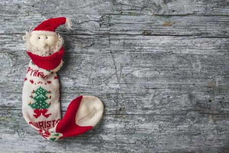 Santa Christmas sock on rustic wooden background with blank space for text or photoの写真素材