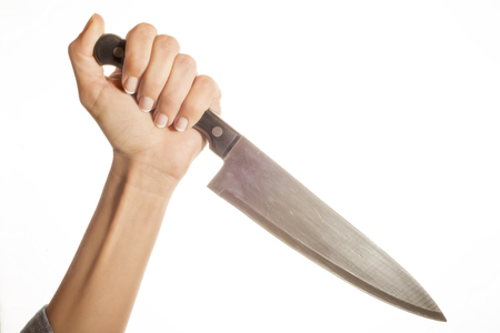 Knife in hand ready to stab isolated on white backgroundの写真素材