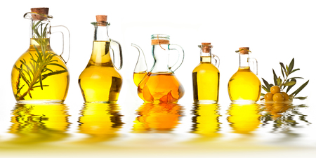 Extra virgin olive oil cruets and olives isolated on white backgroundの写真素材