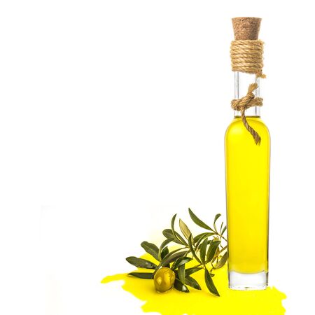 Extra virgin olive oil glass bottle, green olive, branch and oil pouring isolatedの写真素材