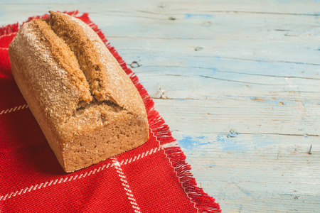 Artisan spelt flour bread on wooden table with copy space