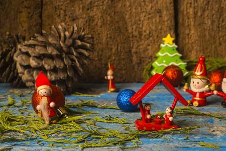 Christmas card,  small ornaments on rustic wooden backgroundの写真素材