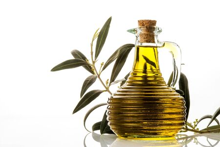 Extra olive oil in glass rustic jar isolated on white backgroundの写真素材