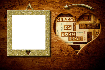 Christmas good wishes greeting and gold empty picture frame hanging old wood wall.の写真素材