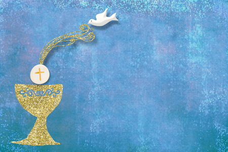 First Holy Communion invitations, gold chalice and dove on blue background with empty space for text and photosの写真素材