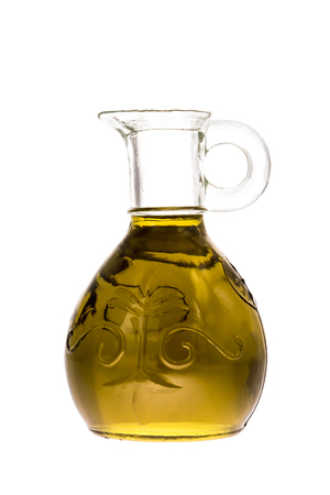 Extra virgin olive oil first cold pressed in a glass bottle isolated on whiteの写真素材