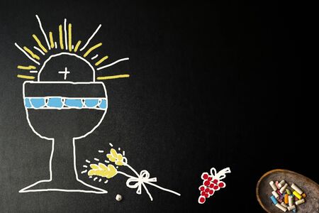 First Holy Communion invites, blackboard with children's drawings of christian symbols and copy space to write invitation and put photo.の写真素材