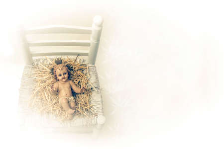 Christmas greeting card. Ancient figure of Child Jesus on an old chair, white background
