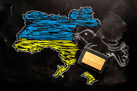 Invasion of Ukraine concept. End of peace in Ukraine due to the invasion of Russia, peace dove and map of Ukraine erased from a blackboard. Stop War.の写真素材