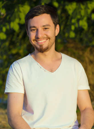 portrait of a young man with a beard outdoorsの写真素材