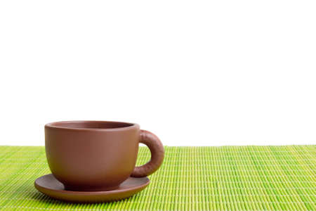 clay teacupClay teacup on the mat isolated on whiteの写真素材