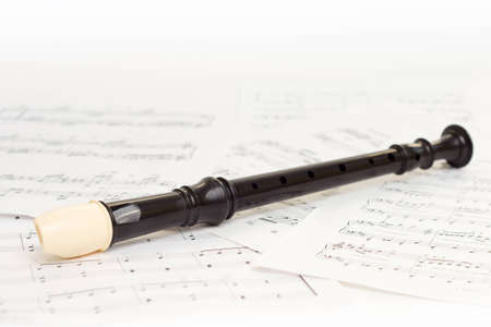 After concert flute  on a musical paper isolatedの写真素材