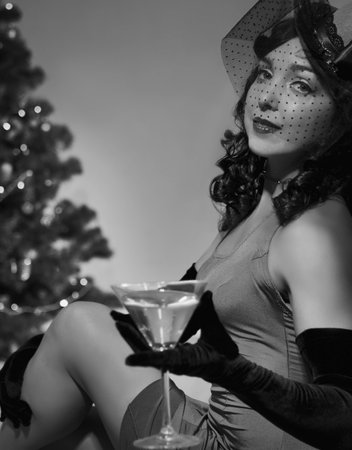 Woman sitting near a Christmas treeの写真素材