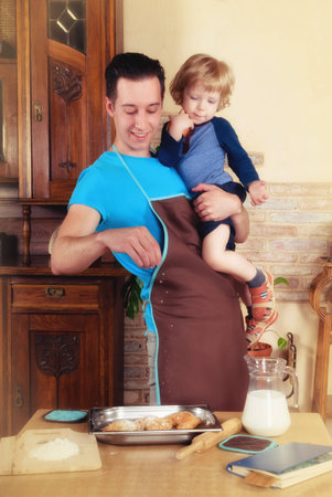 man with little boy in the kitchen preparing a meal. retroの写真素材