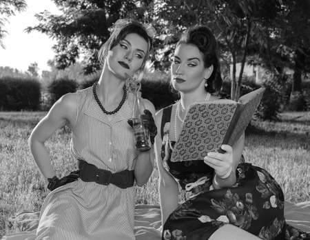 Two girl fashionista watch magazine retro style.の写真素材