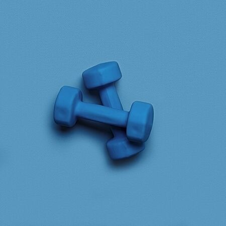 two blue dumbbells on a blue monochrome backgroundの写真素材