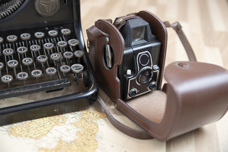 Detail of the keys of an old typewriter, with an old camera and a mapの写真素材