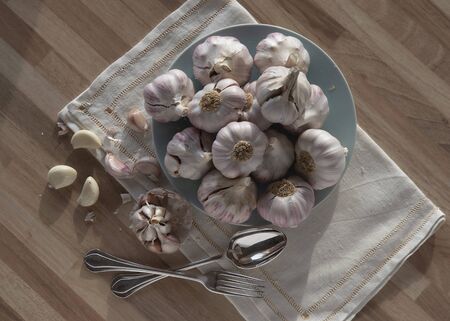 Garlic heads in a plate on a table