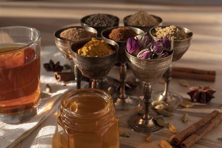 Assortment of different spices in small metal glasses