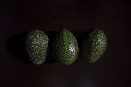 Close-up of fresh avocado on black backgroundの写真素材