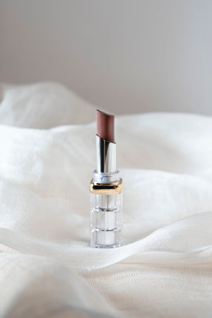 Open tube of lipstick with a bright backgroundの写真素材