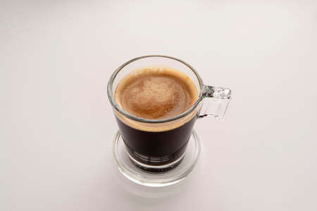 Black coffee in a glass cup and saucerの写真素材