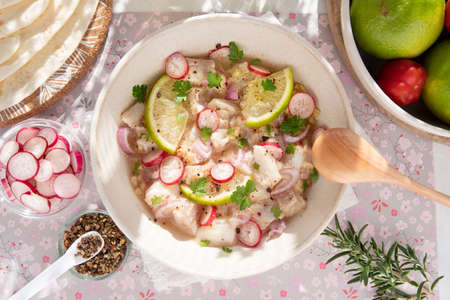 Close-up of a Peruvian ceviche with pieces of fish and lemonsの写真素材