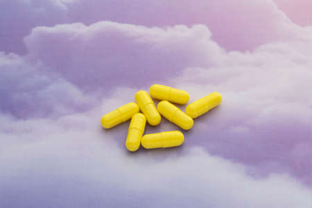 Close-up of medicines with ingredients in cups around them