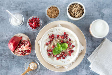 Close-up of a bowl of millet semolina with pomegranate seedsの写真素材