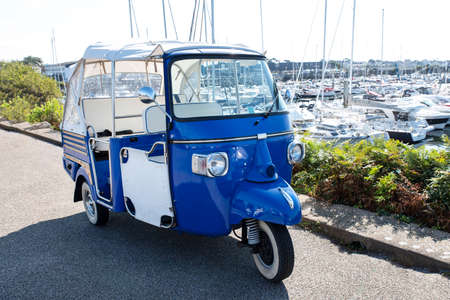 Close-up of a rickshaw on a road beside a port in Brittany, France