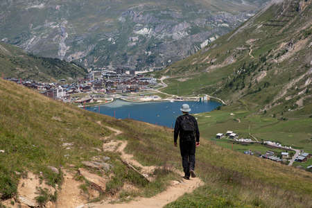 A summer hiker looking at the resort of Tignes in Franceの写真素材